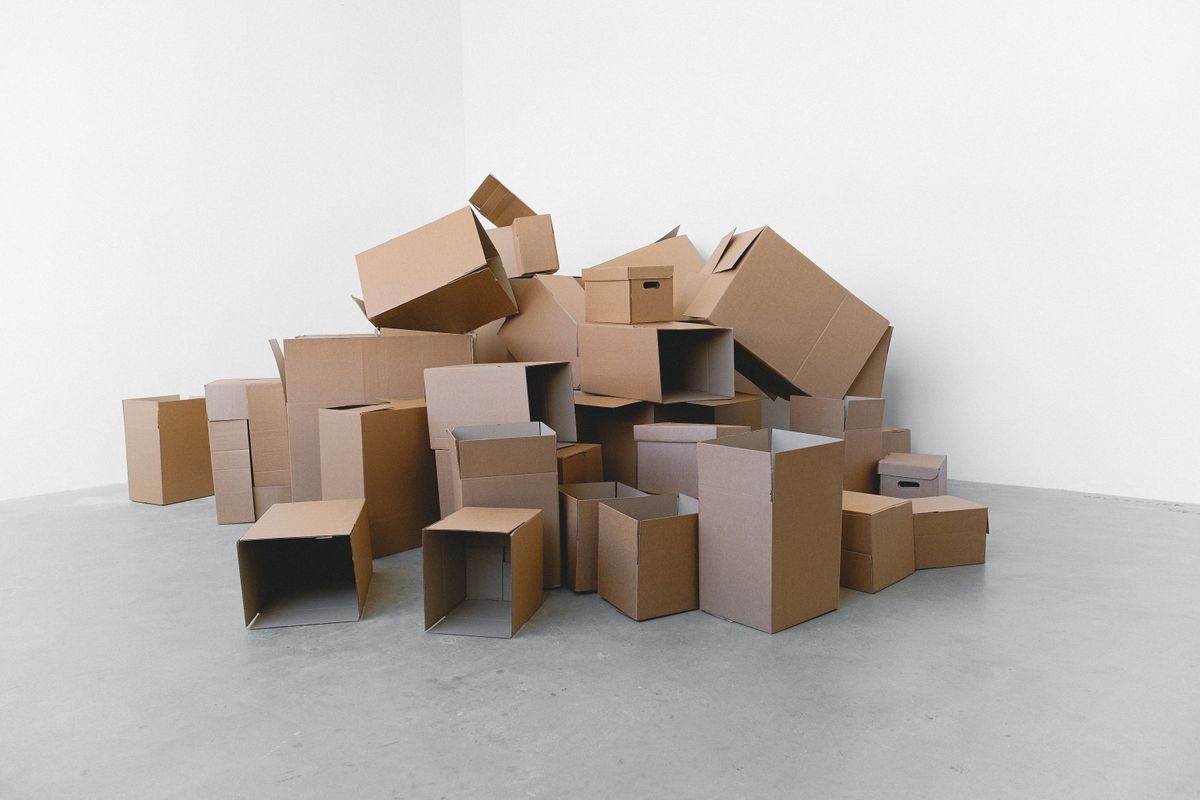 Moving boxes stacked in a home during an estate cleanout and downsizing project